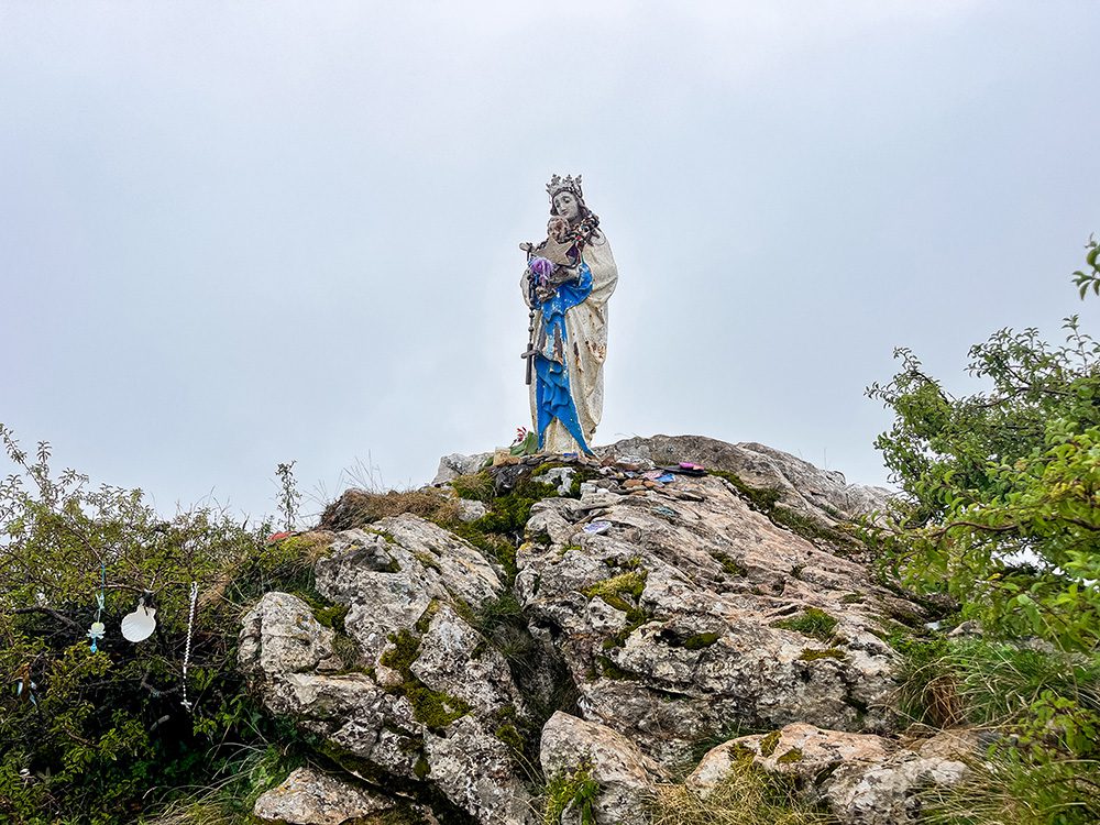 Statue of the Vierge d’Orisson on a rocky outcrop beside the Camino Francés in the Pyrenees.