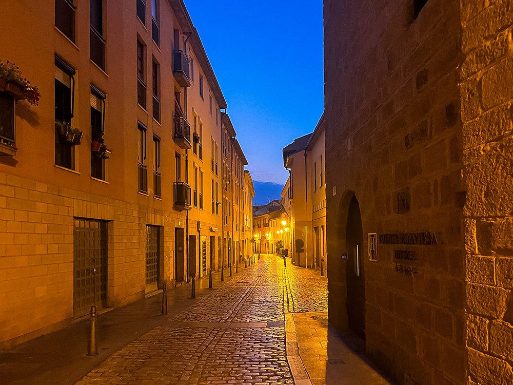 Quiet early-morning street in Logroño illuminated by street lights on the Camino Francés
