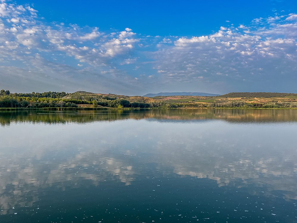 Grajera reservoir reflecting the morning sky in Parque de la Grajera near Logroño