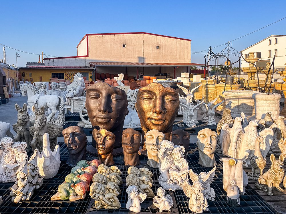 Stone statues and garden ornaments displayed beside the Camino Francés route to León