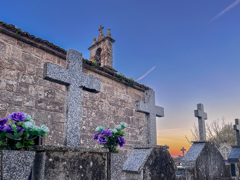 Stone crosses and graves beside the small church at San Xulián on the Camino Francés