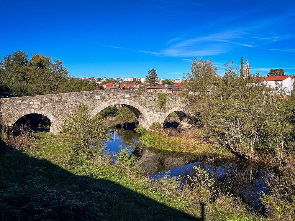 Medieval stone bridge over the River Furelos on the Camino Francés approaching Melide
