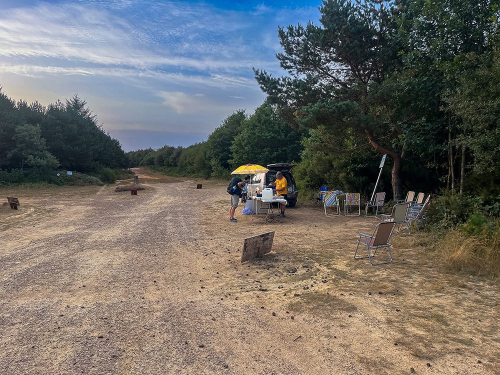 Dr Coffee serving a pilgrim from his roadside coffee stall in the forest on the Camino Francés