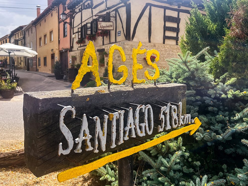 Camino de Santiago sign in Agés showing 518 km remaining to Santiago
